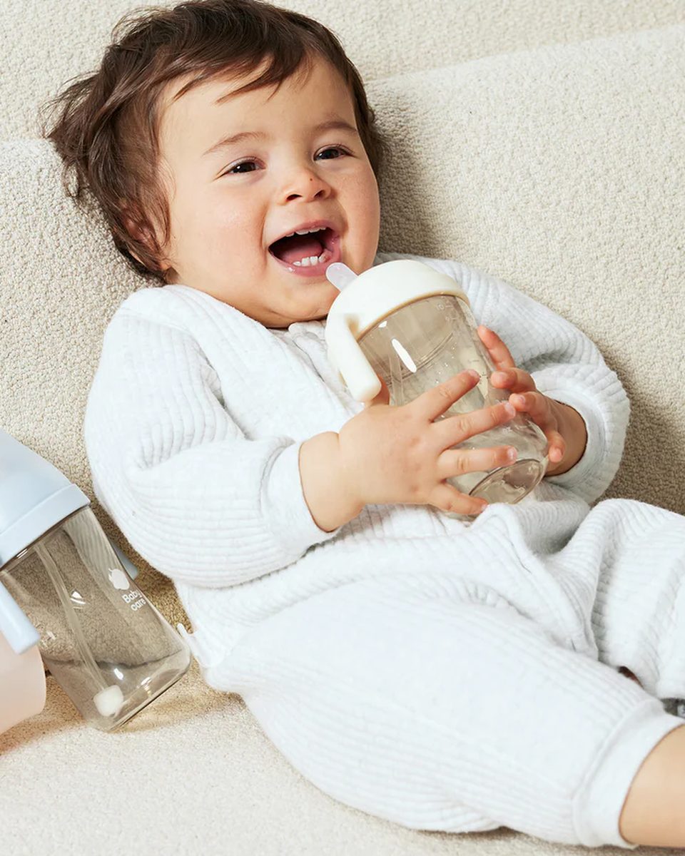 Toddler drinking from the Tilted Anti-Spill Sippy Cup