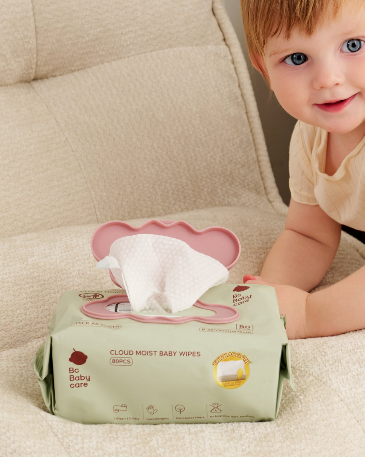 Toddler beside a pack of Cloud Moist Baby Wipes