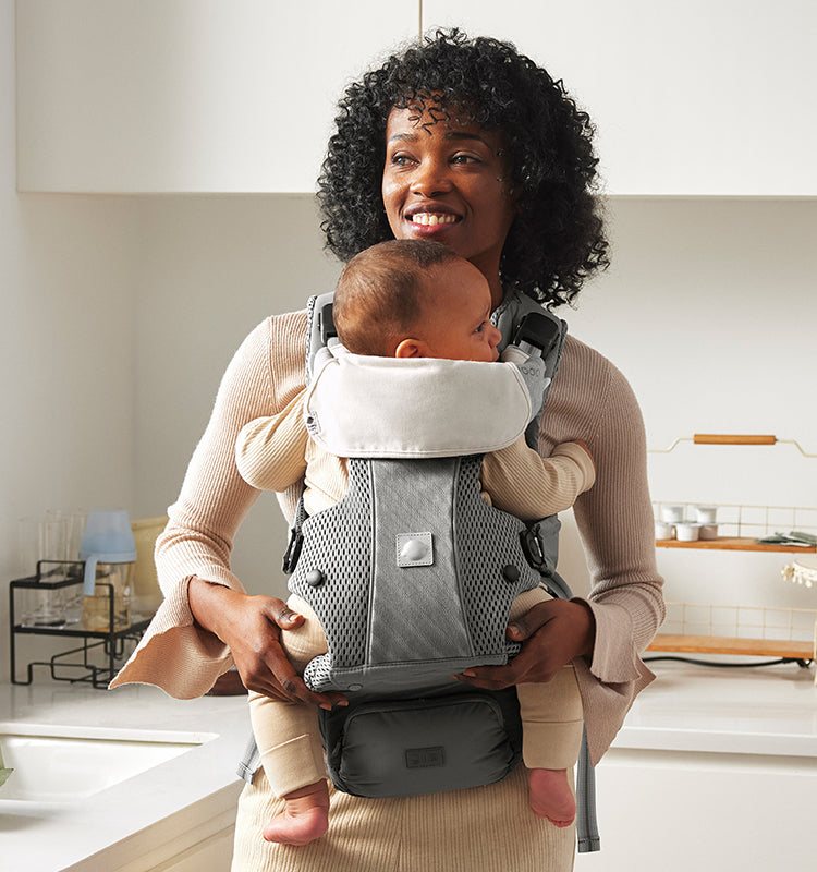 A parent wearing a Babycare carrier
